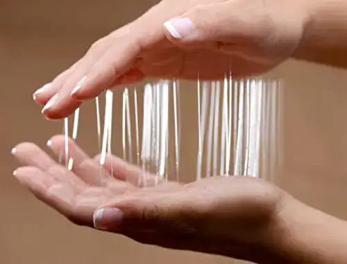 String cheese being pulled apart, showing its stretchy, melty texture.